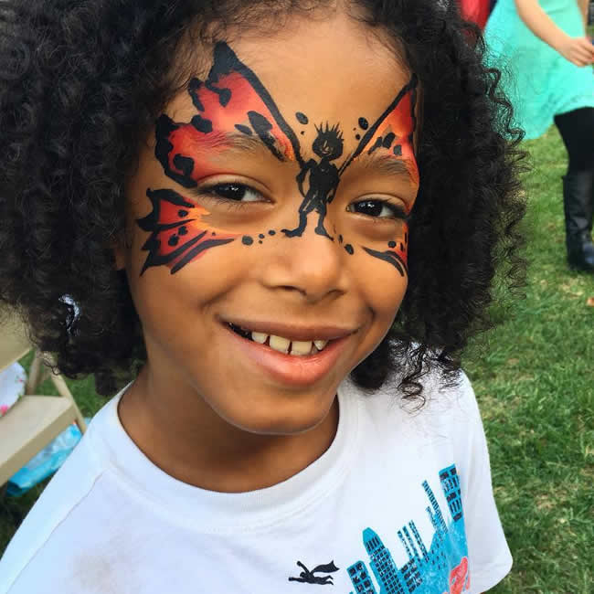 a teen boy with a cool butterfly facepainting